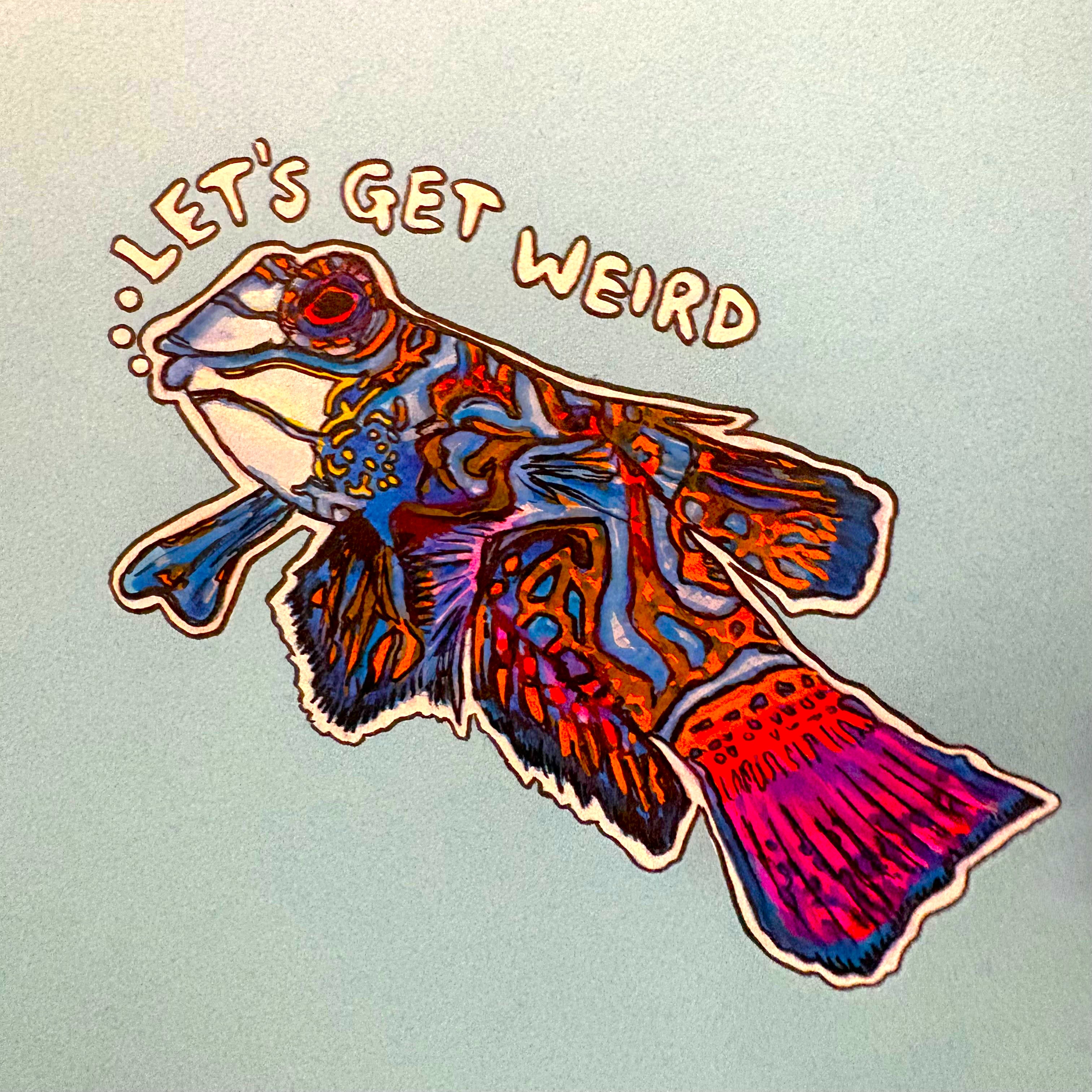 A mixed media illustration of a Mandarinfish saying Let's Get Weird against a light blue background.